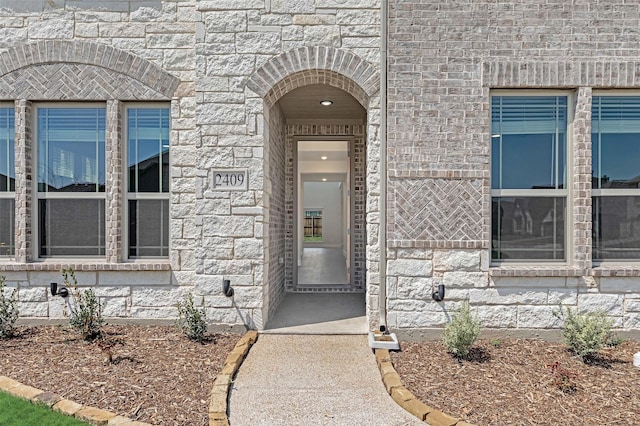 view of exterior entry featuring stone siding