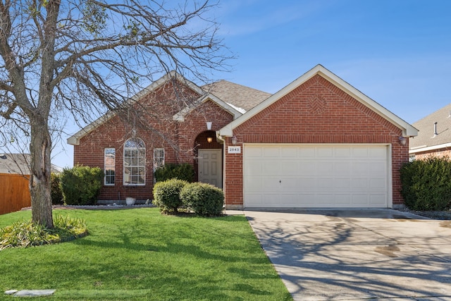 view of front of house featuring a garage and a front lawn