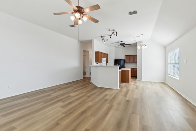 unfurnished living room with light hardwood / wood-style floors, lofted ceiling, and ceiling fan with notable chandelier