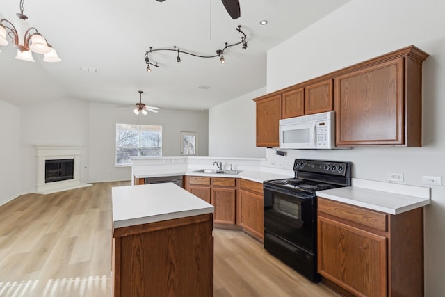 kitchen with sink, light hardwood / wood-style floors, kitchen peninsula, hanging light fixtures, and black range with electric cooktop