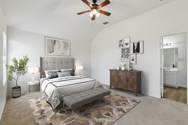 carpeted bedroom featuring vaulted ceiling, ensuite bathroom, and ceiling fan