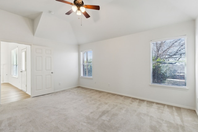 carpeted empty room featuring lofted ceiling and ceiling fan