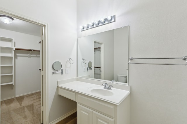 bathroom featuring toilet and vanity