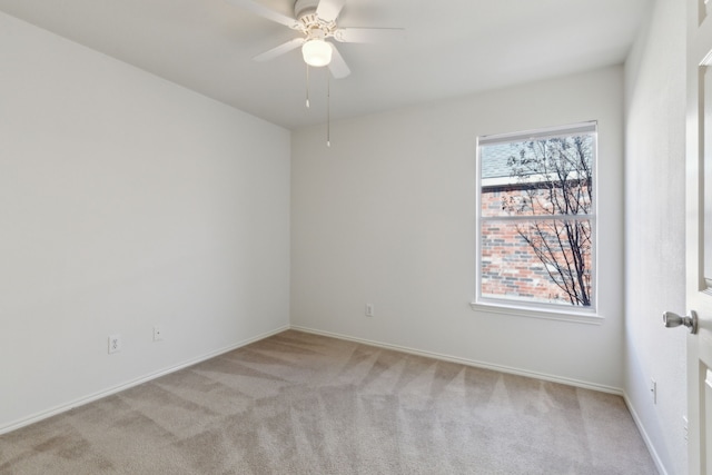 unfurnished room featuring light carpet and ceiling fan