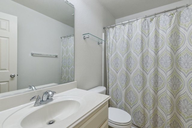 bathroom with toilet and vanity