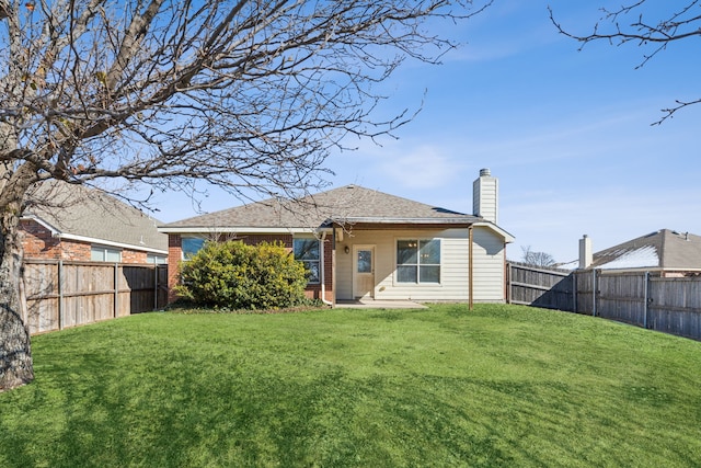 rear view of property with a lawn