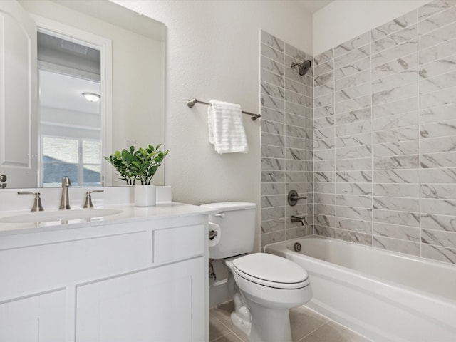 full bathroom with toilet, vanity, tile patterned floors, and tiled shower / bath