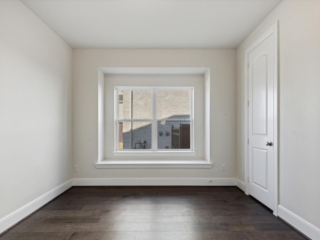 unfurnished room with dark hardwood / wood-style floors