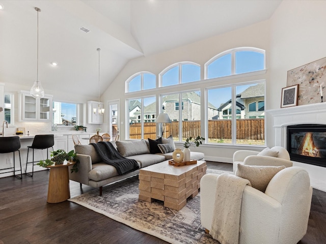 living room with high vaulted ceiling and dark hardwood / wood-style floors