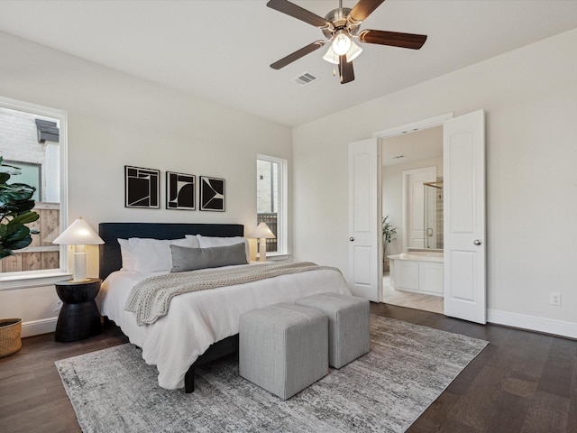 bedroom with connected bathroom, ceiling fan, and dark hardwood / wood-style floors