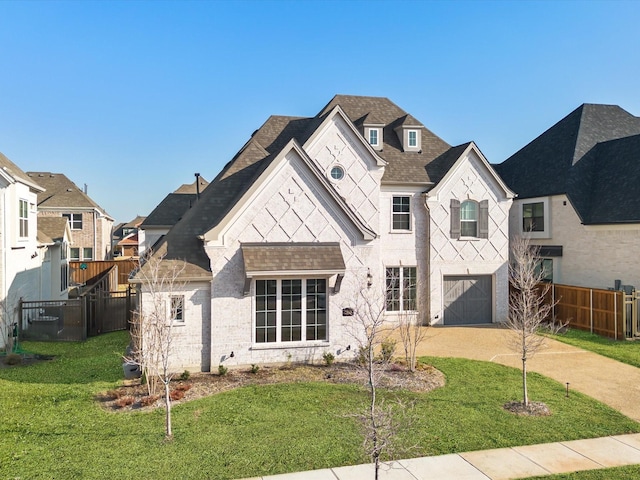 view of front of property featuring a front lawn and a garage