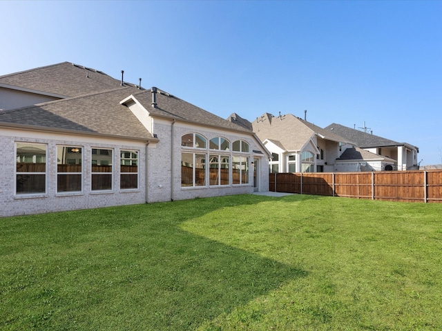 rear view of house with a lawn