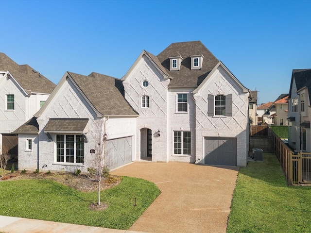 view of front of property with a front yard, a garage, and cooling unit