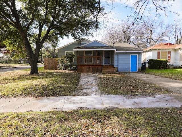 bungalow-style house featuring a porch and a front lawn