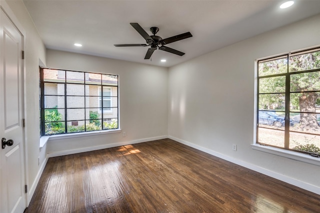 empty room featuring ceiling fan and dark wood-type flooring