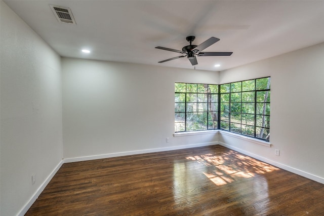 empty room with ceiling fan and dark hardwood / wood-style floors