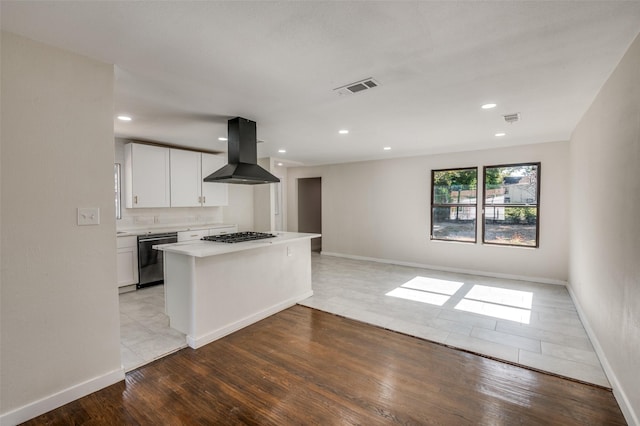 kitchen with dishwasher, light hardwood / wood-style flooring, island range hood, stainless steel gas cooktop, and white cabinetry