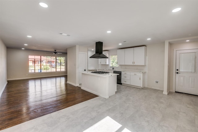 kitchen with sink, white cabinets, black dishwasher, ceiling fan, and island range hood