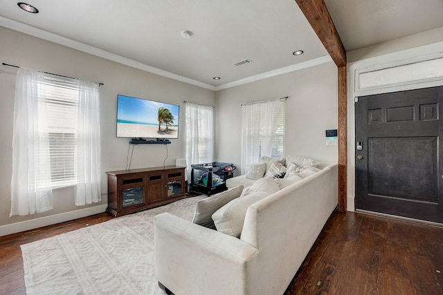 living room featuring hardwood / wood-style flooring, crown molding, and beam ceiling