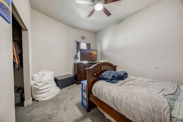 bedroom featuring ceiling fan and light carpet