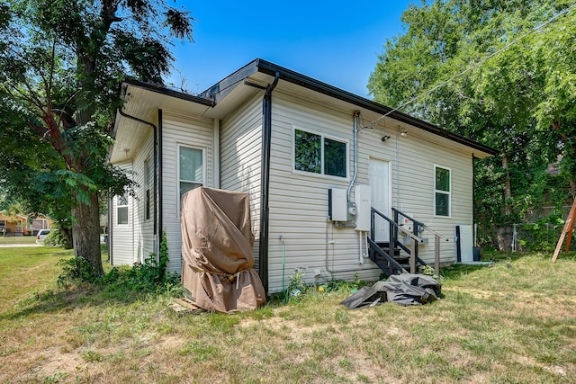 rear view of property with a yard