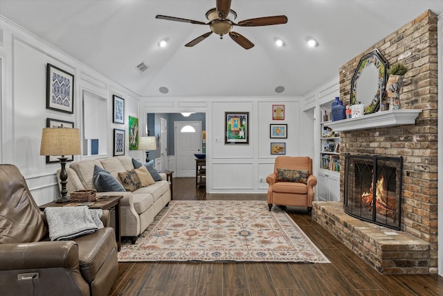 115 Juanita Ave, Wills Point, TX 75169 - living room featuring a decorative wall, built in features, a ceiling fan, wood finished floors, and a brick fireplace