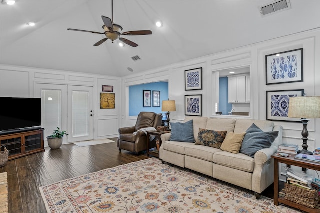 living room with ceiling fan, lofted ceiling, and wood-type flooring