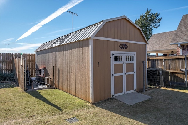 view of outdoor structure with a yard and central air condition unit