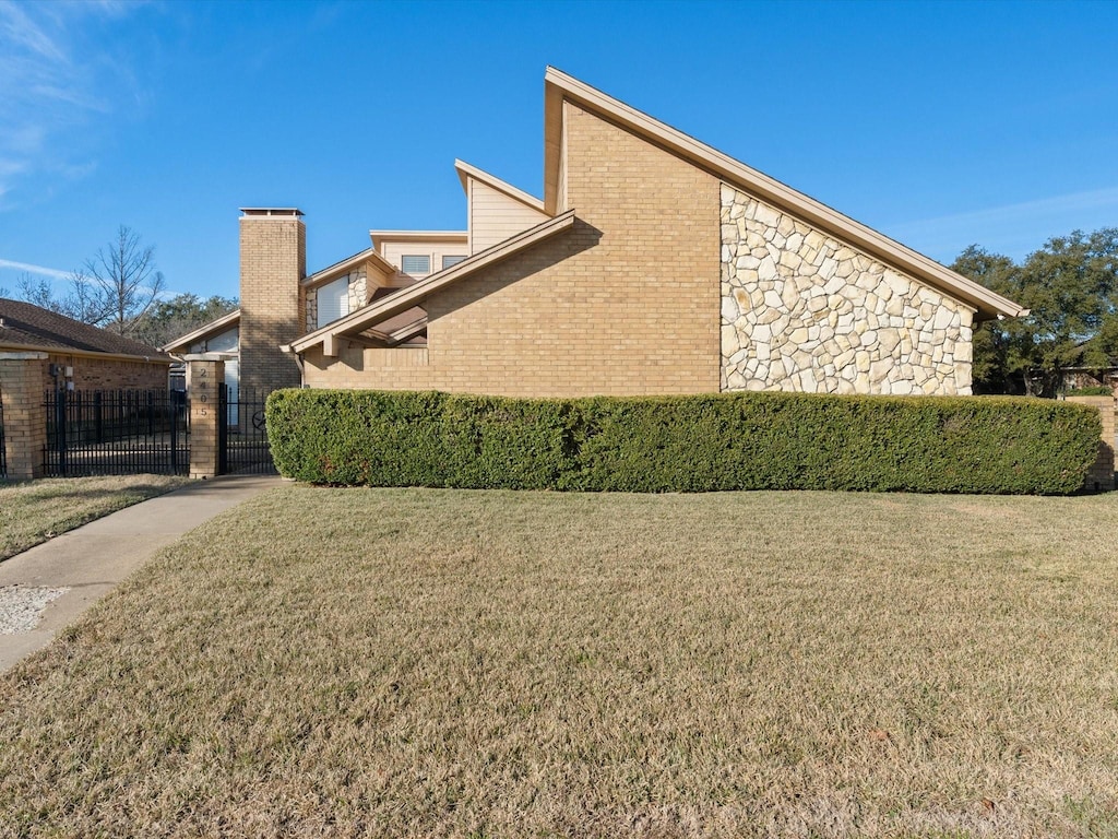 view of side of home with a lawn