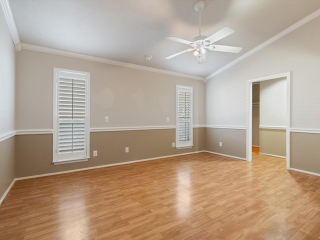 empty room with lofted ceiling, ceiling fan, crown molding, and light hardwood / wood-style flooring