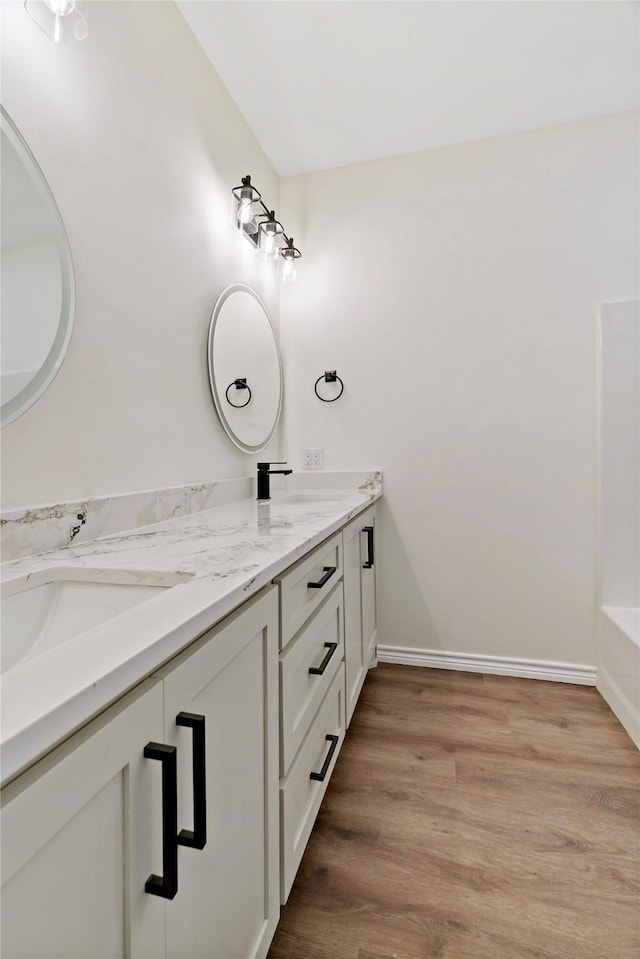 bathroom featuring hardwood / wood-style floors and vanity