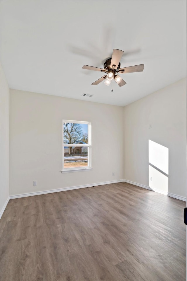 spare room with ceiling fan and wood-type flooring