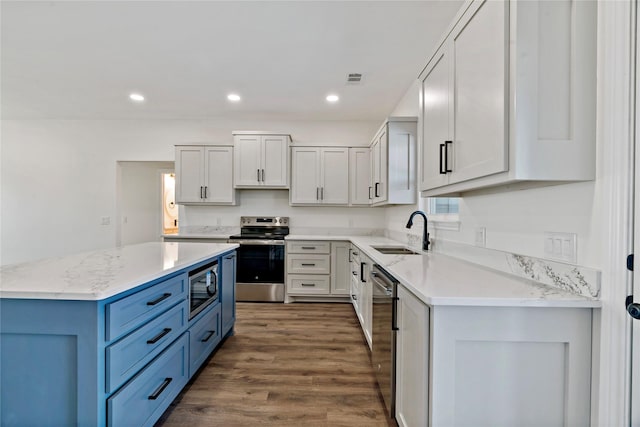 kitchen featuring sink, appliances with stainless steel finishes, blue cabinets, and white cabinetry