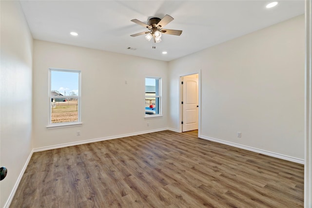 spare room with ceiling fan and dark hardwood / wood-style flooring