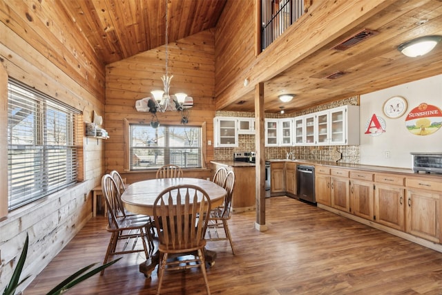 dining room with high vaulted ceiling, an inviting chandelier, hardwood / wood-style flooring, and wood ceiling