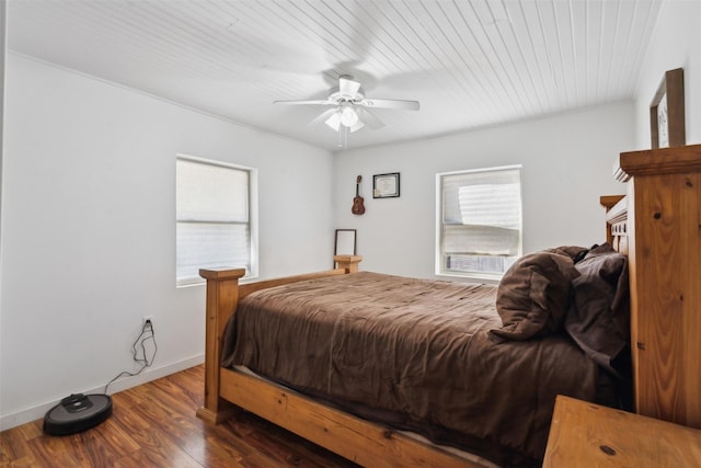 bedroom featuring multiple windows, ceiling fan, and dark hardwood / wood-style floors