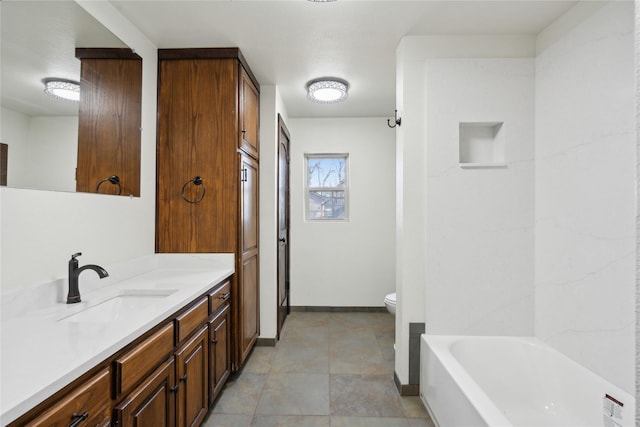 bathroom featuring toilet, a washtub, and vanity