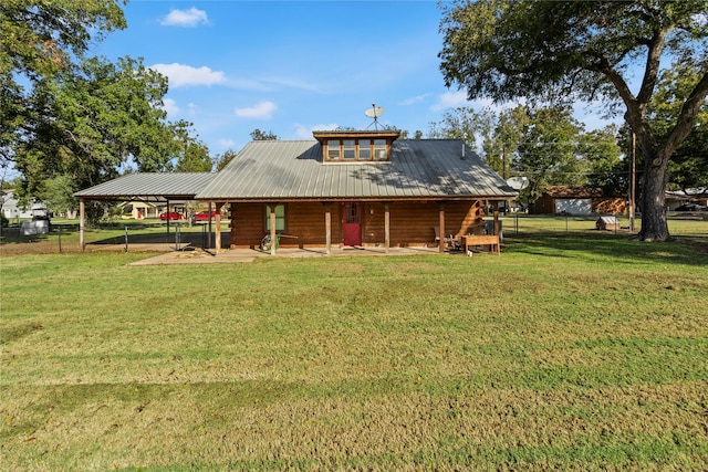 rear view of property with a lawn