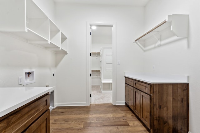 washroom with laundry area, dark wood finished floors, gas dryer hookup, hookup for an electric dryer, and washer hookup