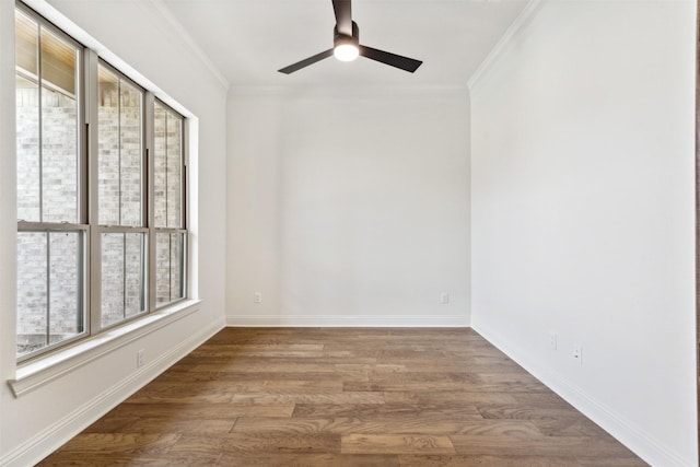 empty room with crown molding, baseboards, ceiling fan, and wood finished floors