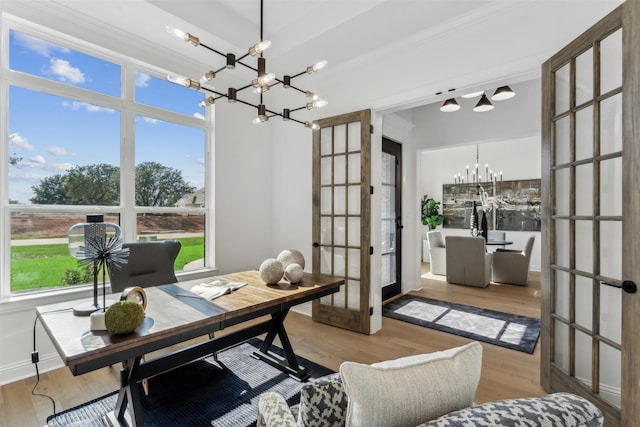 office space featuring light hardwood / wood-style floors, french doors, and an inviting chandelier