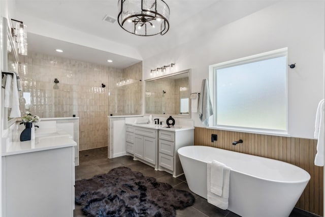 bathroom featuring tile patterned flooring, a notable chandelier, separate shower and tub, and vanity