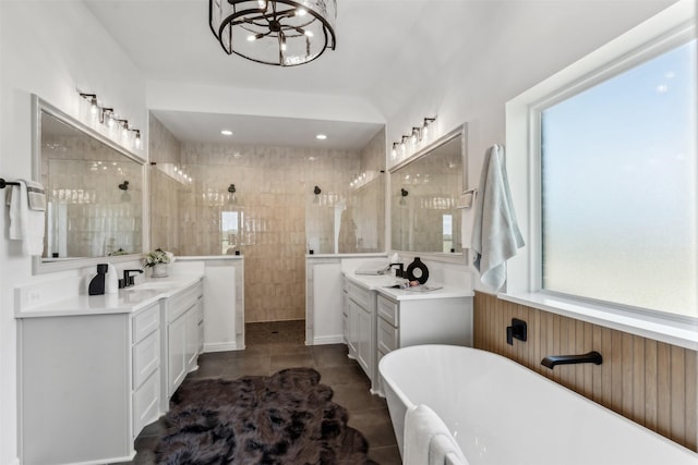 bathroom featuring tile patterned flooring, plus walk in shower, a chandelier, and vanity