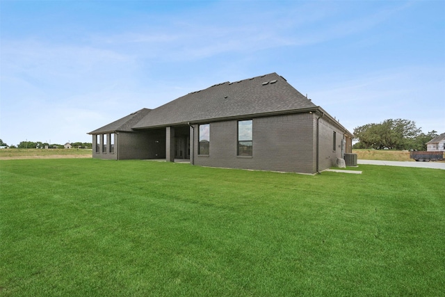 back of house with a yard and cooling unit