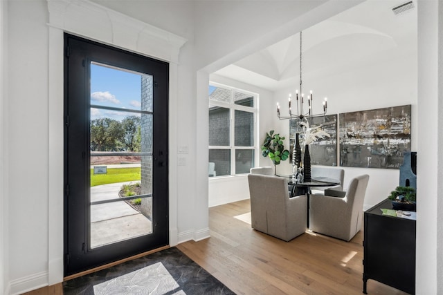 dining space with a notable chandelier and wood-type flooring