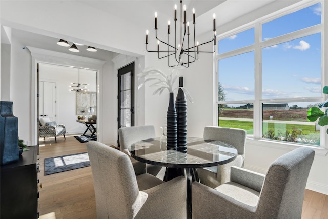 dining room featuring hardwood / wood-style floors and a chandelier