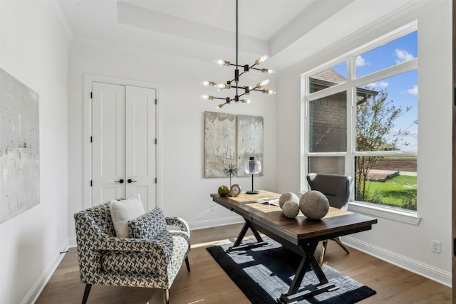 office space with wood-type flooring, a notable chandelier, crown molding, and a wealth of natural light