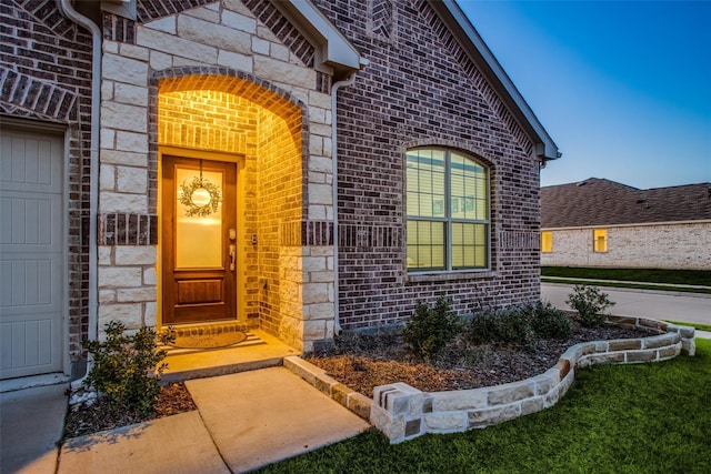 view of exterior entry featuring a garage