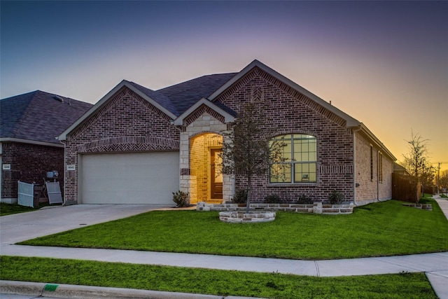 view of front of house featuring a garage and a yard