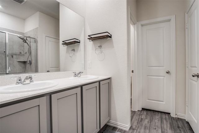 bathroom featuring vanity, hardwood / wood-style floors, and a shower with shower door